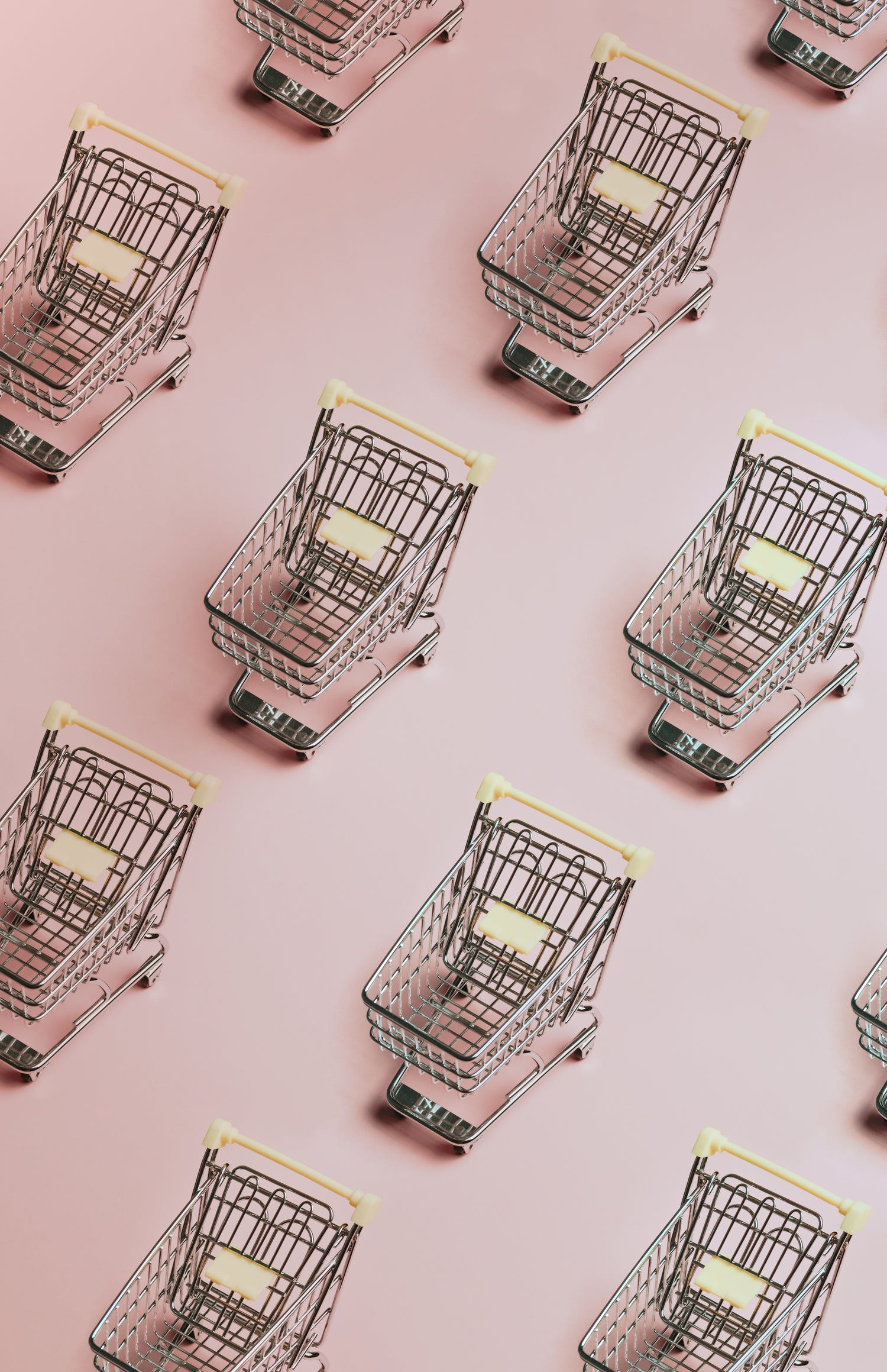 PATTERN-OF-SILVER-SHOPPING-CARTS-ON-A-PINK-BACKGROUND